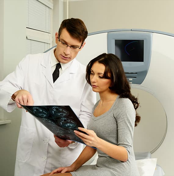 A physician reviewing imaging with a patient